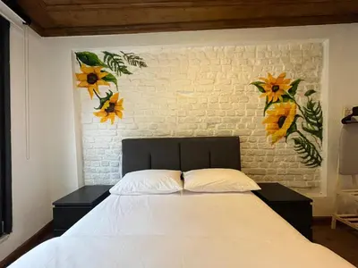 a bedroom with a white bed with flowers on the wall at Casa Mirasol Terrace Golden Horn Istanbul in Istanbul