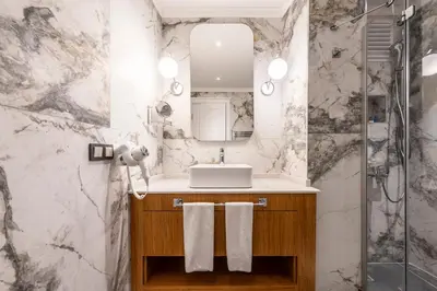 a bathroom with a sink and a mirror at Sedef Apartments Pera in Istanbul