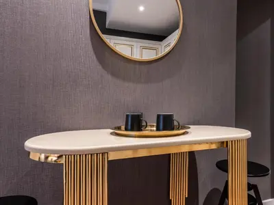 a dressing table with a mirror and two mugs on it at Sedef Apartments Pera in Istanbul