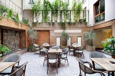 an outdoor patio with tables and chairs and plants at Sedef Apartments Pera in Istanbul