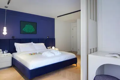 a bedroom with a large bed with a blue wall at G Residences Gayrettepe in Istanbul