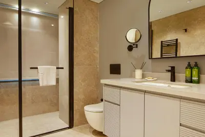 a bathroom with a toilet and a sink and a shower at G Residences Gayrettepe in Istanbul