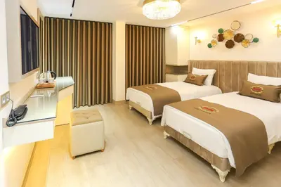 a hotel room with two beds and a table at Safa Hotel Old City in Istanbul