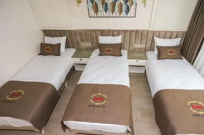 three beds in a hotel room with certificates on them at Safa Hotel Old City in Istanbul