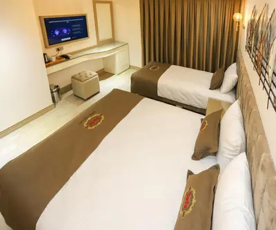 a hotel room with two beds and a television at Safa Hotel Old City in Istanbul