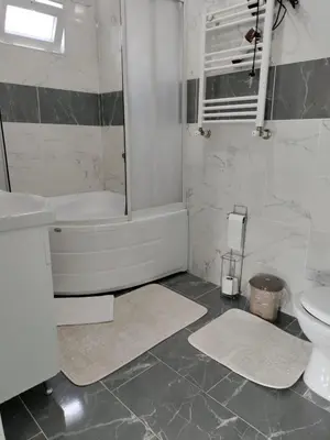 a bathroom with a tub and a sink and a toilet at Villaferhat mavi in Karacaköy