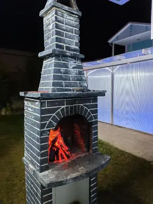 a brick oven with a fire inside of it at Villaferhat mavi in Karacaköy