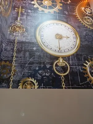 a gold clock hanging from a ceiling with clocks at Bonita Boutique in Istanbul
