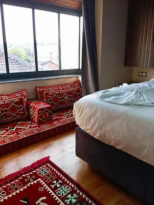 a bedroom with a bed and a couch next to a window at Bonita Boutique in Istanbul