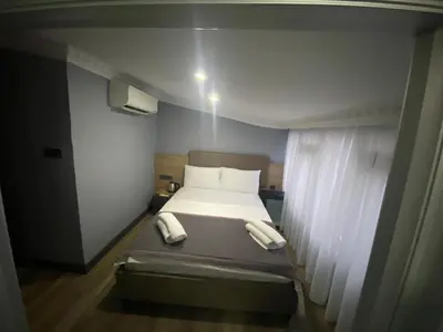 a small bedroom with a bed and a window at Sirkeci Esen Apart in Istanbul