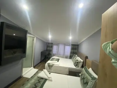 a small room with a bed and a flat screen tv at Sirkeci Esen Apart in Istanbul