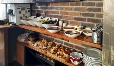 a shelf with bowls and other dishes on it at Sirkeci Esen Apart in Istanbul