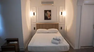 a bedroom with a bed with towels on it at Global Termal Hotel in Çekirge