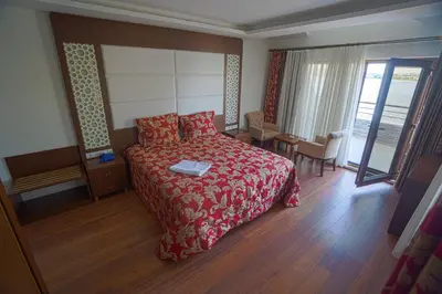 a hotel room with a bed and a table and chairs at Sea Garden Otel in Darıca