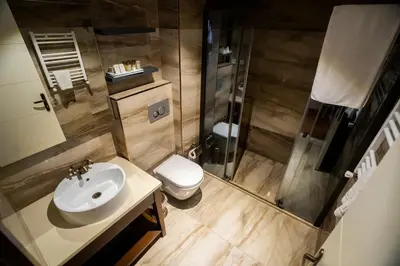 a bathroom with a sink and a shower and a toilet at Sea Garden Otel in Darıca
