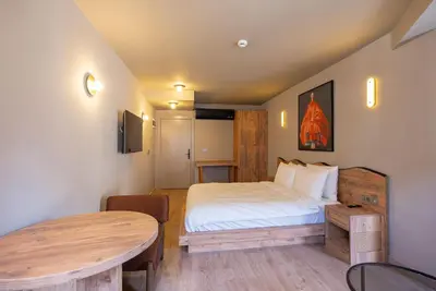 a small bedroom with a bed and a table at Tare Houses in Istanbul