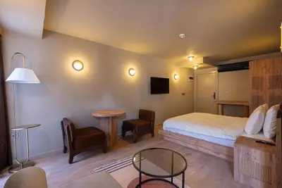 a hotel room with a bed and a table and chair at Tare Houses in Istanbul