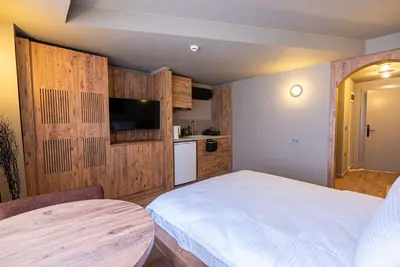 a bedroom with a white bed and a table at Tare Houses in Istanbul