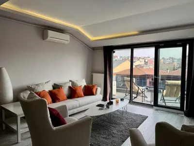 a living room with a couch and a large window at Bomonti 42 Suites in Istanbul