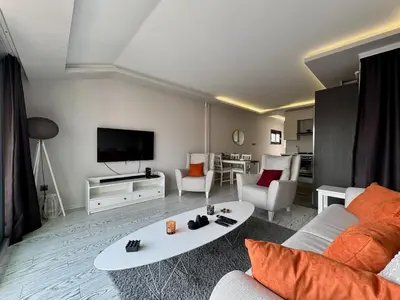 a living room with a couch and a tv at Bomonti 42 Suites in Istanbul