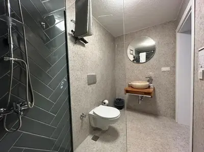 a bathroom with a toilet and a glass shower at Villa Arancia Istanbul - Garden, BBQ, Sauna & Turkish Bath by the Tram in Fatih in Istanbul