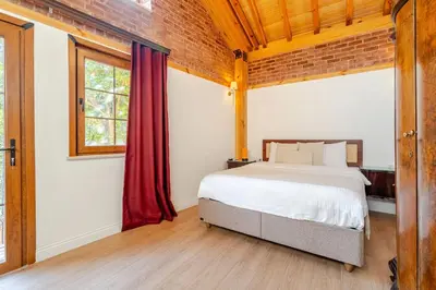 a bedroom with a bed and a brick wall at Villa Arancia Istanbul - Garden, BBQ, Sauna & Turkish Bath by the Tram in Fatih in Istanbul