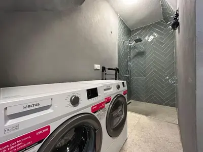 a washing machine in a bathroom with a shower at Villa Arancia Istanbul - Garden, BBQ, Sauna & Turkish Bath by the Tram in Fatih in Istanbul