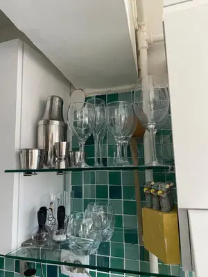 a bunch of wine glasses on a shelf in a kitchen at An Unforgettable Experience in Istanbul