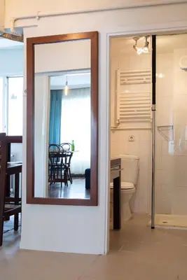 a mirror on a wall in a room with a bathroom at An Unforgettable Experience in Istanbul