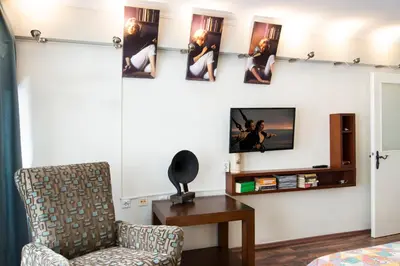 a living room with a chair and a tv on a wall at An Unforgettable Experience in Istanbul