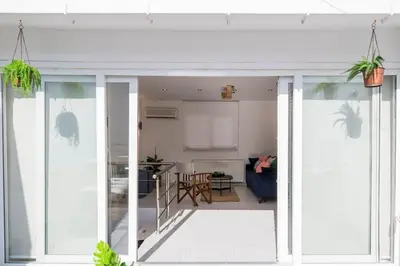a living room and kitchen with sliding glass doors at Stylish Duplex House with a Special Terrace in Istanbul