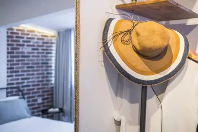 a straw hat is hanging on a wall at Stylish Duplex House with a Special Terrace in Istanbul