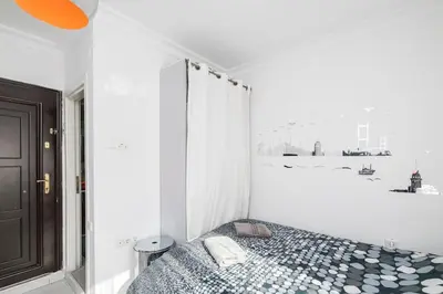 a bedroom with a bed in a white room at Cute 1 Room w AC 300 meters to Istiklal Street in Istanbul