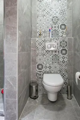 a bathroom with a toilet and a tiled wall at Cute 1 Room w AC 300 meters to Istiklal Street in Istanbul
