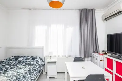 a bedroom with a bed and a desk and a table at Cute 1 Room w AC 300 meters to Istiklal Street in Istanbul