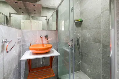 a bathroom with an orange sink and a shower at Cute 1 Room w AC 300 meters to Istiklal Street in Istanbul