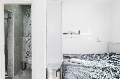 a white bathroom with a bed and a shower at Cute 1 Room w AC 300 meters to Istiklal Street in Istanbul