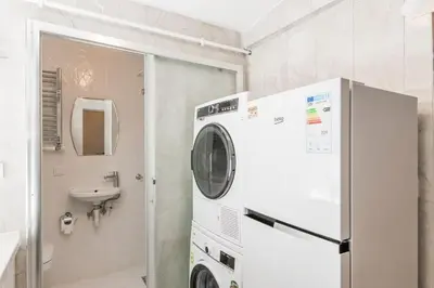 a washing machine in a bathroom with a sink at Beautiful 2BR House w/AC 400meters Taksim Square in Istanbul