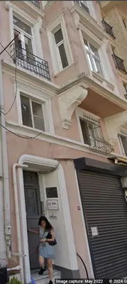 a woman walking out of a house with a mask on at Beautiful 1 Br Apt. w/AC 400 meters Taksim Square in Istanbul