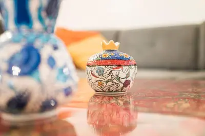 a small vase with a crown sitting on a table at Beautiful 1 Br Apt. w/AC 400 meters Taksim Square in Istanbul