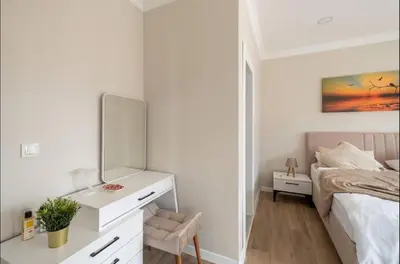 a white bedroom with a bed and a mirror at Stylish 2BR and 3BR Izmit Apartments- Chic & Cozy in Çavuşçiftliği