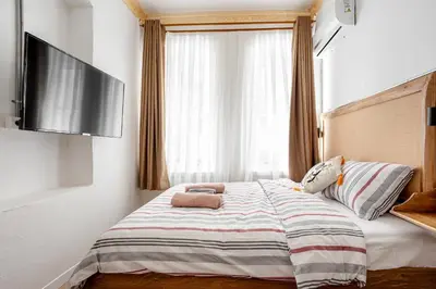 a bedroom with a bed with a flat screen tv at Armel Homes Galata in Istanbul