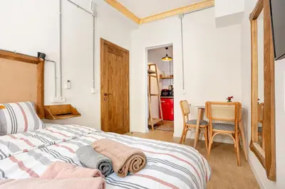 a bedroom with a bed and a table and chairs at Armel Homes Galata in Istanbul