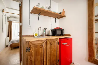 a kitchen with a red refrigerator and a microwave at Armel Homes Galata in Istanbul
