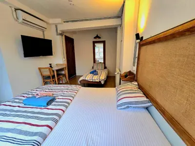 a hotel room with two beds and a television at Armel Homes Galata in Istanbul