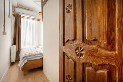 a bedroom with a wooden door with a bed at Armel Homes Galata in Istanbul
