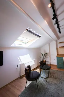 a living room with a skylight and two chairs and a table at Evra Suites Hotel in Istanbul