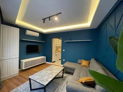 a living room with blue walls and a couch at Evra Suites Hotel in Istanbul