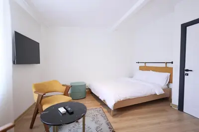 a bedroom with a bed and a table and a chair at Evra Suites Hotel in Istanbul