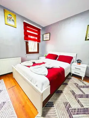 a bedroom with a large white bed with red pillows at Taksim Ottoman Style Hotel in Istanbul